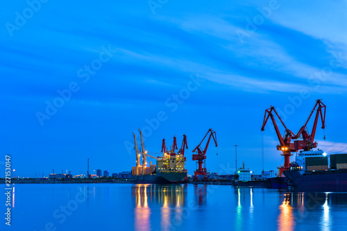 Slika na platnu Night, cranes at harbour docks are busy working