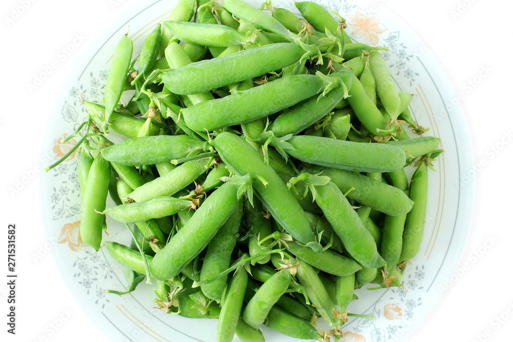 fresh green pea pods and green peas isolated on the white background fresh green pea pods and green peas isolated on the white background