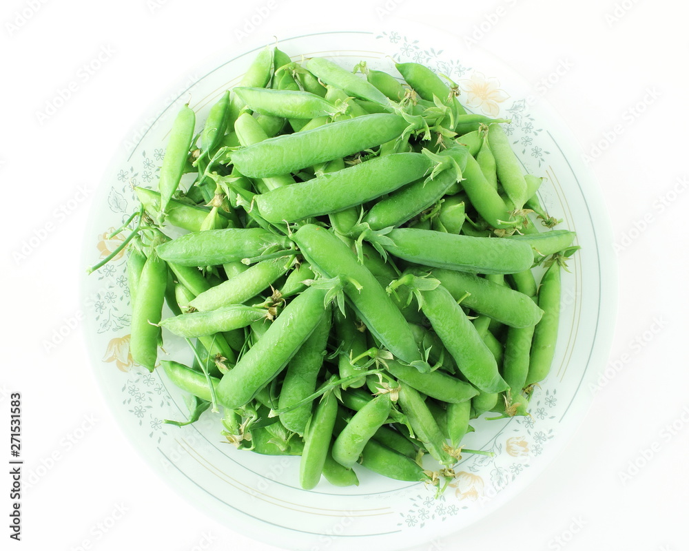 fresh green pea pods and green peas isolated on the white background fresh green pea pods and green peas isolated on the white background