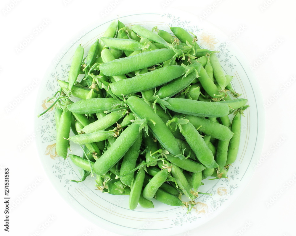 fresh green pea pods and green peas isolated on the white background