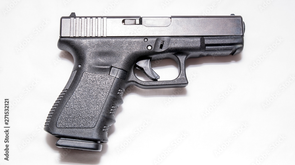 A black 9mm pistol isolated on a white background