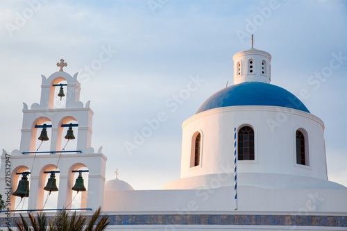 beautiful Oia town on Santorini island, Greece. Traditional white architecture and greek orthodox churches with blue domes over the Caldera, Aegean sea. Scenic travel background