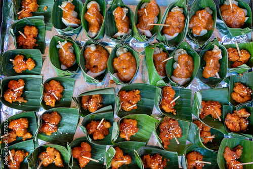 Traditional indonesian snack in green palm leaves . Close up. Asian food background, buffet table © OlegD