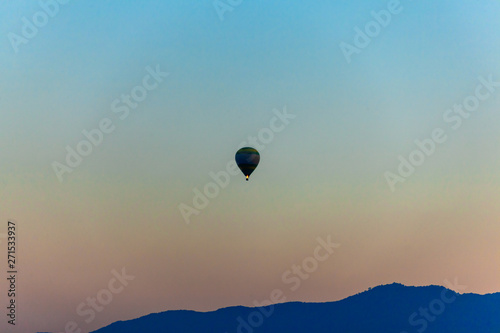Silhouette of Colorful  hot air balloon is flying  over mountain  in blue sky at sunset  © TAK TUP ICE W