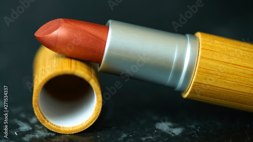 Zero-waste, plastic-free lipstick, refillable, reusable bamboo makeup, macro closeup selective focus. photo