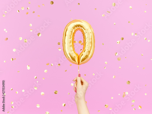Zero on pink. Female hand holding Number 0 foil balloon. 3d rendering photo