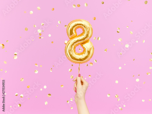 Eight year birthday. Female hand holding Number 8 foil balloon. Eight-year anniversary background. 3d rendering