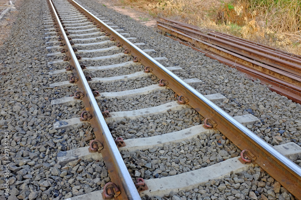Steel support rails with concrete sleepers strewn with gravel Steel support rails with concrete sleepers strewn with gravel
