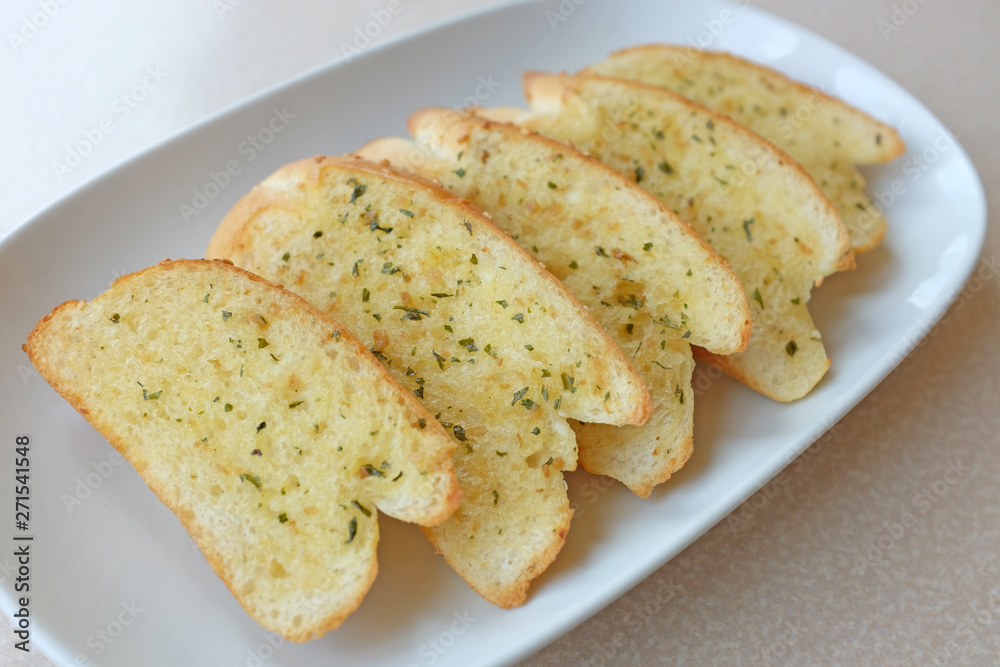 Home-made Garlic and herb bread slices on plate Home-made Garlic and herb bread slices on plate