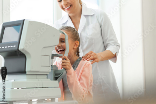 Laughing cute girl with braided hair having fun while dealing photo