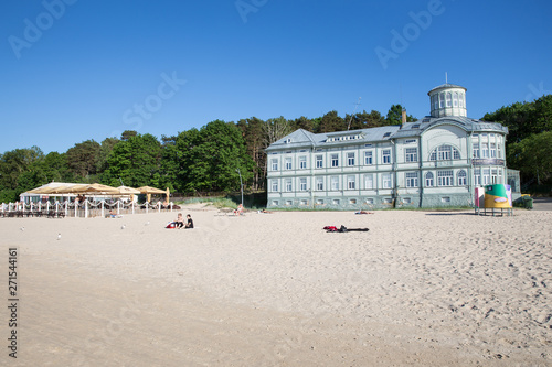 City Jurmala, Latvian Republic. Peoples walking on sand beach. Urban view with tourists and buildings.Travel photo. 2019. 4. Jun