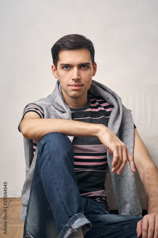 portrait of young man sitting on sofa