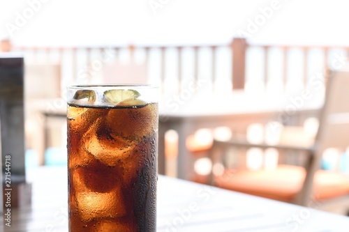 Black soft drinks in glass on the table.