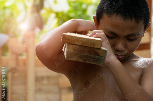 Little boy labor working in commercial building structure, World Day Against Child Labour concept or Children violence and abused concept with copy space for advertisers.
