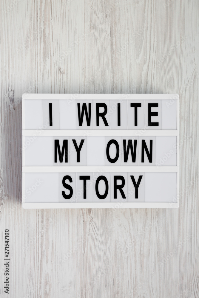 'I write my own story' words on a lightbox on a white wooden background. From above, overhead, flat lay, top view. 'I write my own story' words on a lightbox on a white wooden background. From above, overhead, flat lay, top view.