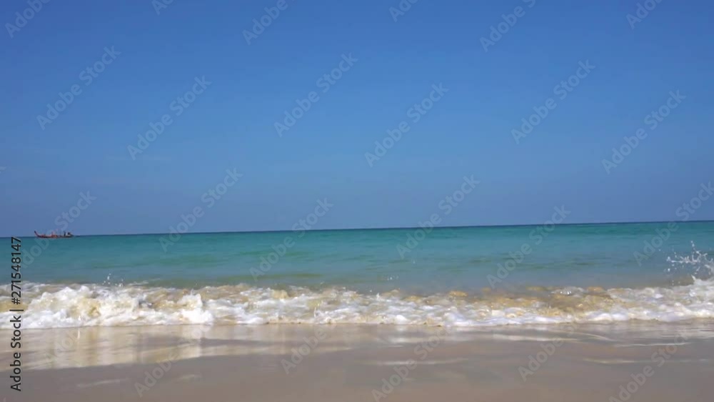 Waves and Golden sand. View of the horizon and ocean. White foam from waves approaching. The water is blue with greenish otenkom. Border between sky and sea. Nature. Waves and Golden sand. View of the horizon and ocean. White foam from waves approaching. The water is blue with greenish otenkom. Border between sky and sea. Nature.