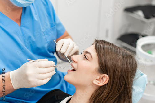 Young beautiful woman in the dentist chair at dental clinic. Medicine, health, stomatology concept. dentist treating a patient. Woman smiling