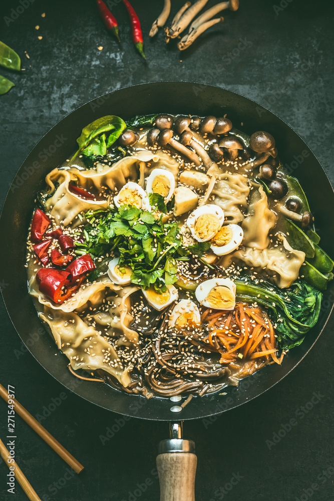 Close up of wok pan with vegetarian korean hot pot and chopsticks on dark  rustic kitchen table background, top view. Copy space. Asian food concept  Stock Photo | Adobe Stock