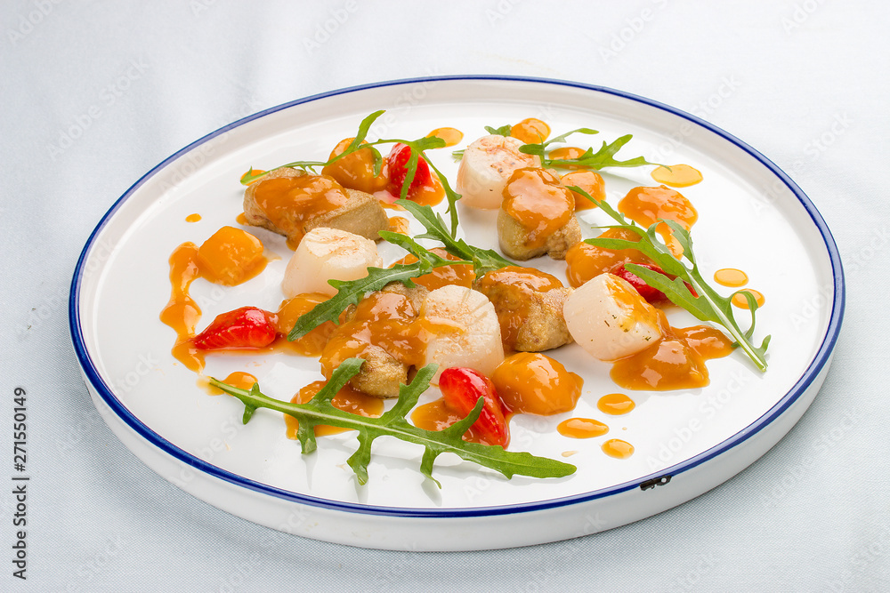 Scallop with strawberries and arugula. On white background