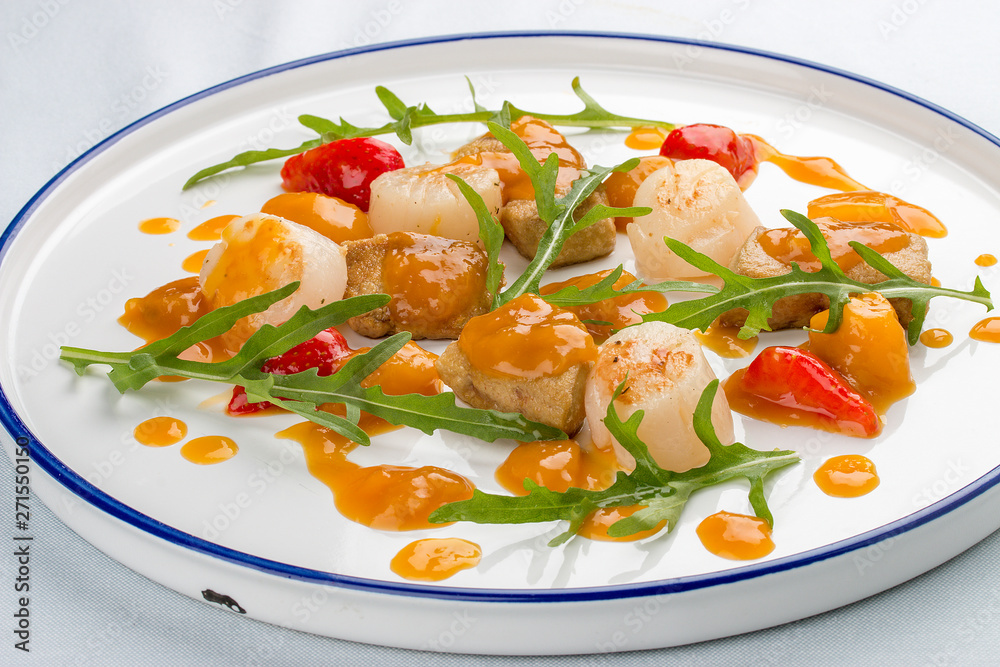 Scallop with strawberries and arugula. On white background Scallop with strawberries and arugula. On white background