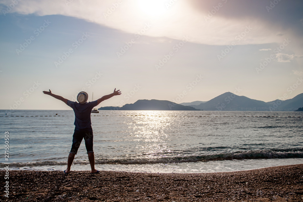 Fototapeta premium Man meets sunset on the sea shore 