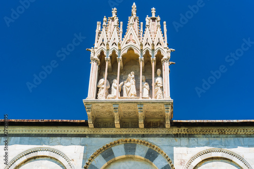 Schilderij op canvas Details of the outer wall of the Camposanto Monumentale Cemetery, Pisa, Italy, crowned by a Gothic tabernacle containing Virgin Mary with Child surrounded by four saints, dating from the 14th century