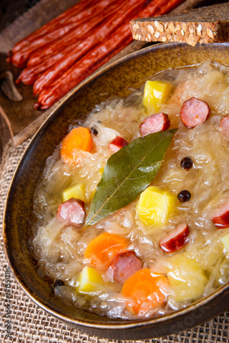 rustic sauerkraut soup with bacon and sausage photo