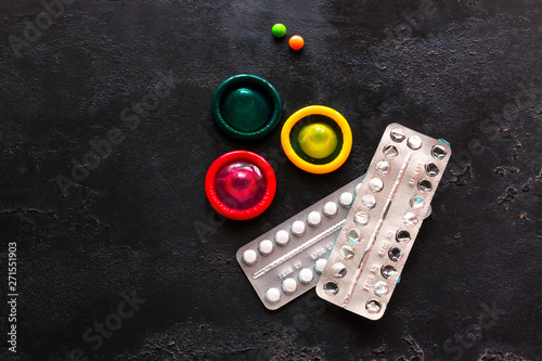 contraceptives on a black background