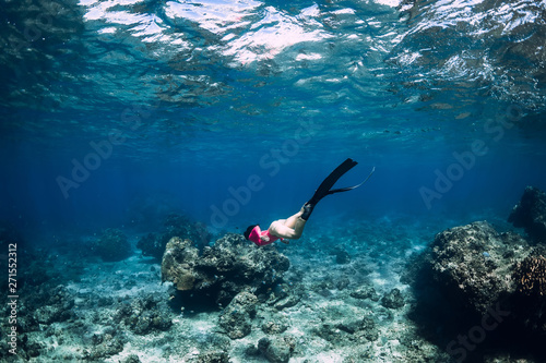 Young woman freediver with fins dive underwater ocean