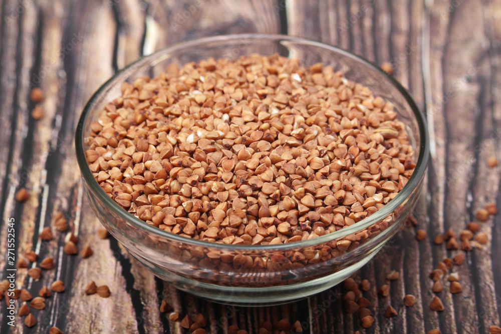 A glass bowl with raw buckwheat