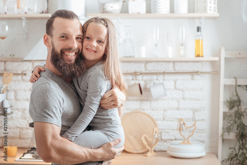 Happy family leisure. Father and daughter relationship. Caring dad holding his kid, hugging, smiling. Happy family leisure. Father and daughter relationship. Caring dad holding his kid, hugging, smiling.