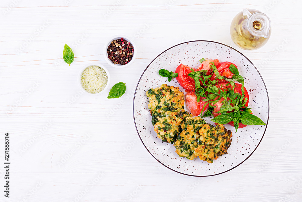 Baked steak chopped chicken fillet with spinach and a side dish of tomatoes  salad. European cuisine. Dietary food. Top view Stock Photo | Adobe Stock