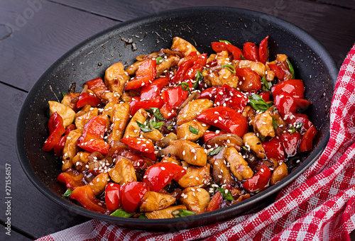 Stir fry chicken, sweet peppers and green onion. Asian cuisine