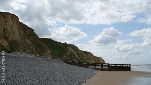 The cliffs of Sheringham beach, a beautiful holiday destination for anyone in the UK, millions of stones leads to golden sand and blue water