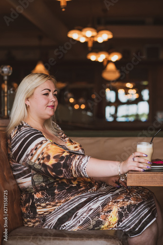 Simple plump woman at city. Lady in cafe rest and enjoy 