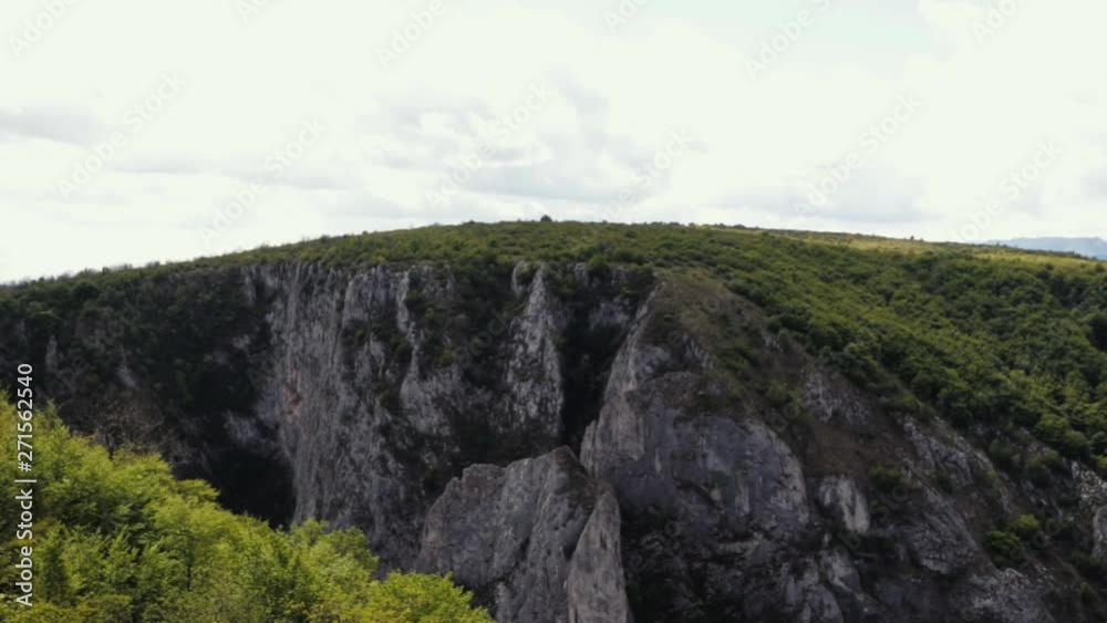 View of the stunning Cheile Turzii gorge - overlooking the far distance mountain chain. Camera panning to the right. View of the stunning Cheile Turzii gorge - overlooking the far distance mountain chain. Camera panning to the right.
