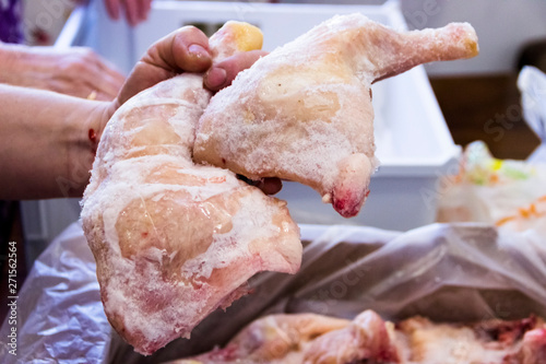 Frozen raw chicken, background macro view from above