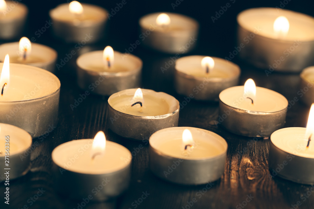candles burning in darkness over black background. commemoration concept. candles burning in darkness over black background. commemoration concept.