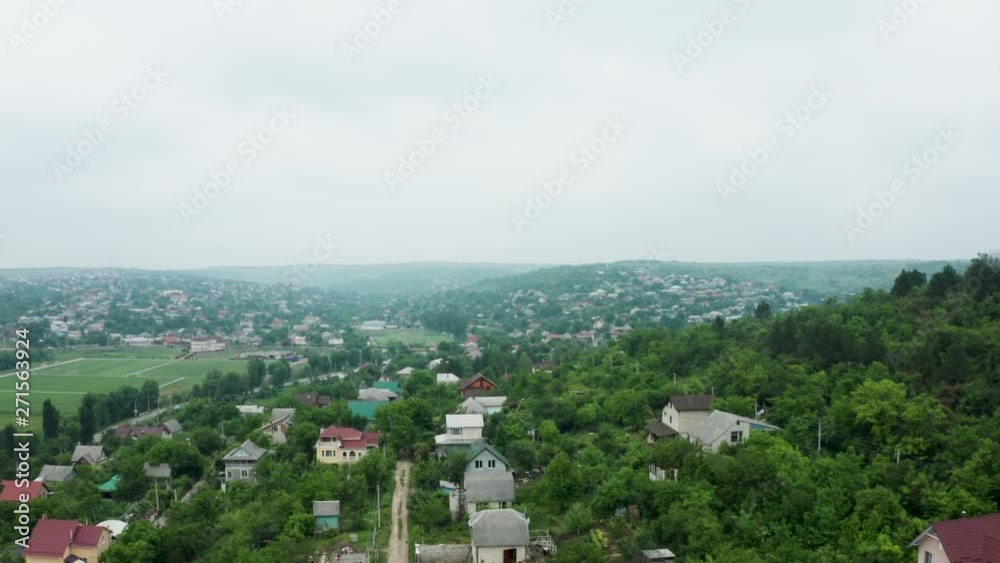 Aerial shot of flying over a residential rural area. Beautiful cozy houses Aerial shot of flying over a residential rural area. Beautiful cozy houses