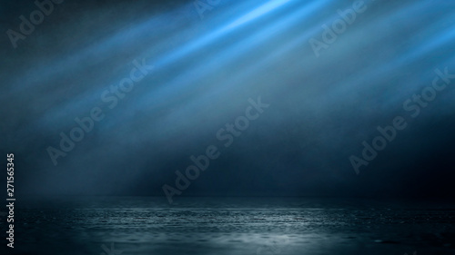 Wet asphalt  reflection of neon lights  a searchlight  smoke. Abstract light in a dark empty street with smoke  smog. Dark background scene of empty street  night view  night city.