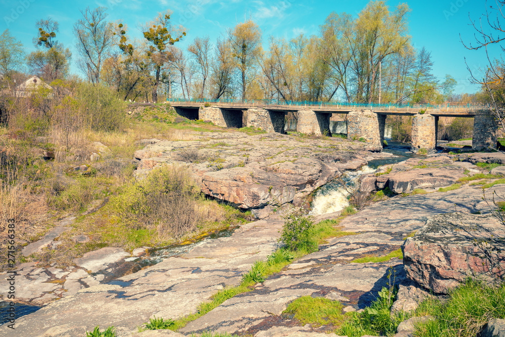 Bridge over the mountain river with the rocky banks Bridge over the mountain river with the rocky banks