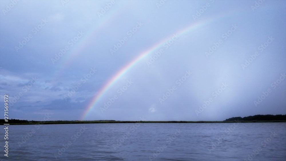 double rainbow over the water double rainbow over the water