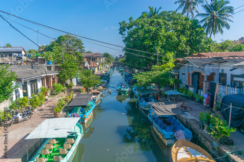 The Dutch colonial Hamilton canal was build in the 17th century and is lined with fishermen houses and huts and runs right through Negombo, Sri Lanka