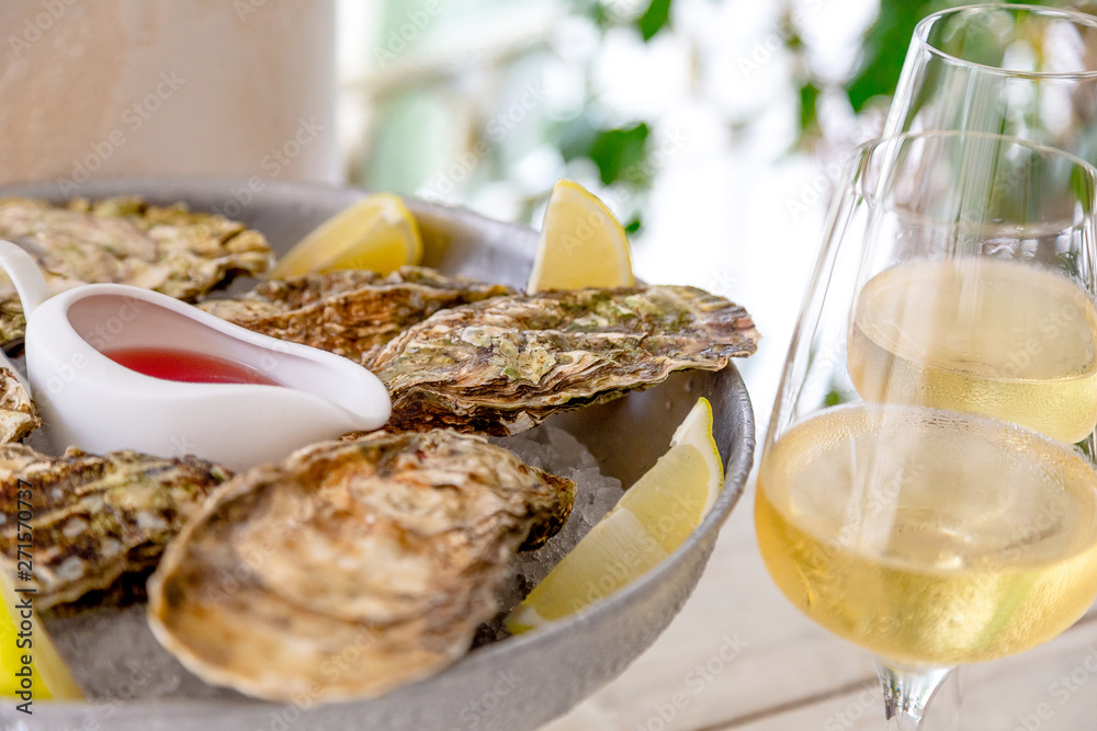 Fresh oysters with ice and white wine. Seafood. White background Fresh oysters with ice and white wine. Seafood. White background