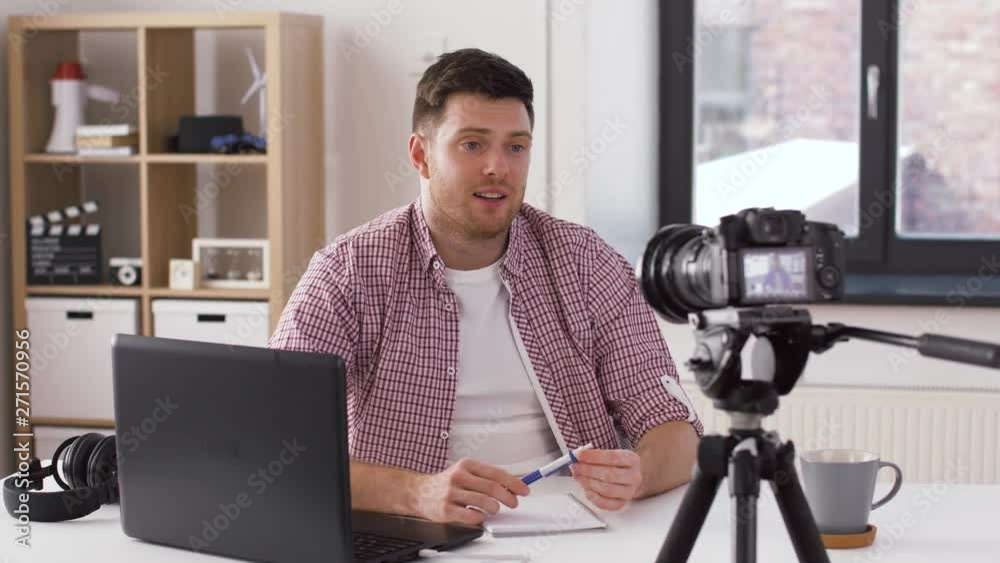 blogging, videoblog and people concept - male blogger with camera recording video at home blogging, videoblog and people concept - male blogger with camera recording video at home