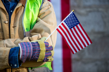 A serious worker man and american flag