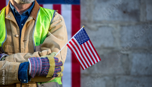 Canvas Print A serious worker man and american flag