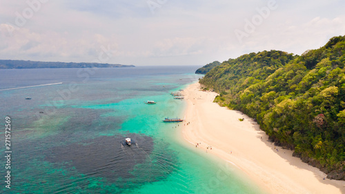 Puka Shell Beach  Boracay Island  Philippines  aerial view. Tropical white sand beach and beautiful lagoon. Tourist boats and people on the beach. People relax on the beautiful coast.