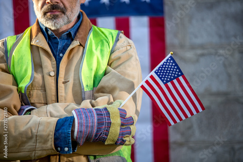 A serious worker man and american flag photo