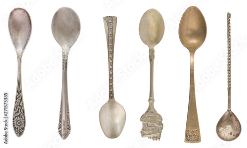 Beautiful old vintage teaspoons isolated on white background. Top view. Retro silverware